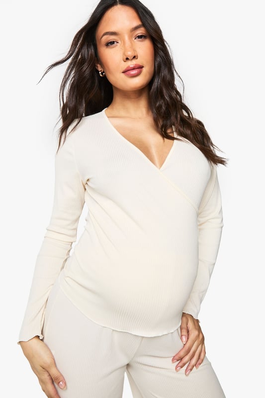Maternity Brushed Rib Wrap Lettuce Hem Top & Trouser Lounge Set Ribbed wrap-style top with elegant ruched hem detail for added texture
Flattering V-neckline that provides comfortable nursing access
Long sleeves for extra warmth during night-time or lounging
Wide-leg trousers with relaxed fit for unrestricted movement
Specially designed to accommodate and flatter your changing shape throughout pregnancy
Embrace comfort without compromising on style with this versatile maternity loungewear set from Boohoo. The thoughtfully designed wrap top features a feminine V-neckline and ruched hem that gently contours your bump, while the soft ribbed fabric moves with your body. The coordinating wide-leg trousers offer the perfect balance of comfort and contemporary style, making this set ideal for relaxing evenings at home or catching up on much-needed rest. Pair with fluffy slippers and a lightweight dressing gown for cooler evenings, or simply enjoy the set on its own during warmer months. This loungewear duo transitions effortlessly from pregnancy to nursing, ensuring you'll enjoy this Boohoo essential long after your little one arrives.