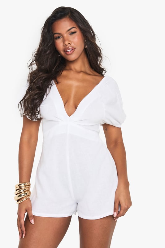 Crafted from a breathable linen mix fabric, perfect for warm-weather styling
        Featuring charming puff sleeves for a feminine, on-trend silhouette
        Flattering V-neckline frames the dcolletage beautifully
        Open back design with delicate tie detail adds a flirty touch
        Relaxed fit with a defined waistline creates a balanced, figure-enhancing shape
    
    This linen mix playsuit from Boohoo combines comfort with effortless style for your casual wardrobe. The puff sleeves add a touch of romance while the V-neckline creates a flattering frame. The open back with tie detail offers a subtle glimpse of skin, perfect for sunny days out. Style with minimal jewellery as seen on our model - think statement earrings and a simple bracelet - and pair with flat sandals for daytime gatherings or family brunches. For a more polished look, add espadrille wedges and a woven clutch. The versatile design works brilliantly for garden parties, seaside holidays or casual weekend outings when you want to look put-together without trying too hard.