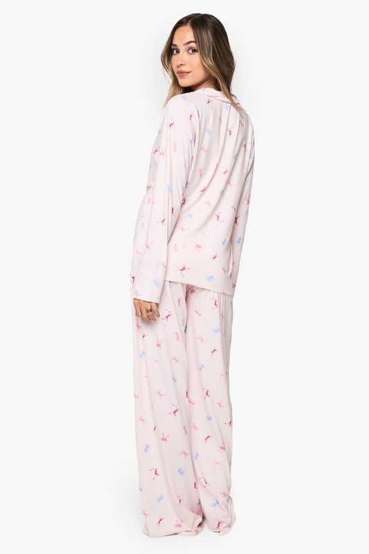 Maternity pyjama set featuring a charming bow print pattern throughout
        Classic button-through shirt design with notched collar for timeless nightwear style
        Relaxed fit with generous cut to accommodate your growing bump comfortably
        Full-length trousers with wide legs for unrestricted movement during sleep
        Long sleeves provide extra warmth and coverage for cooler evenings
    
    Drift into dreamland in absolute comfort with this delightful maternity pyjama set from Boohoo. Designed specifically for mums-to-be, this set combines practicality with style through its relaxed silhouette that grows with you throughout your pregnancy journey. The soft fabric feels gentle against sensitive skin, whilst the classic button-through design makes night feeds and bathroom breaks hassle-free. The wide-leg trousers offer ample room for movement, perfect for finding that elusive comfortable sleeping position. Pair with fluffy slippers and a warm dressing gown for those midnight kitchen trips, or simply lounge around on weekend mornings with a cup of tea and your favourite book. This set strikes the perfect balance between functionality and fashion, ensuring you look and feel your best during this special time.