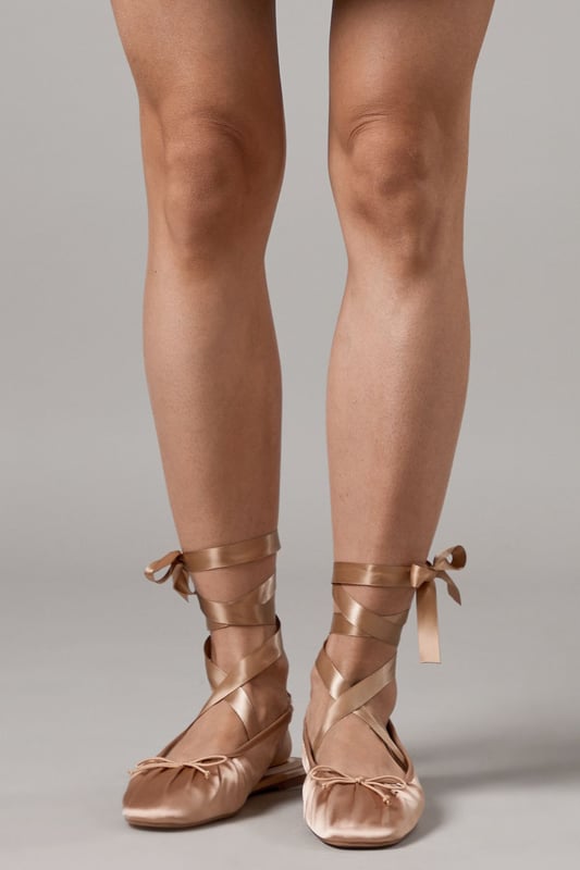 Luxurious satin ballet pumps with elegant ankle tie detail
        Comfortable flat heel measuring between 0-2cm for all-day wear
        Delicate slingback design with secure ribbon ties
        Soft gathered detail at the toe for a feminine finish
        Versatile pointed toe silhouette perfect for both casual and formal styling
    
    The Faith Lia Ballet Pumps combine timeless elegance with contemporary styling. These sophisticated flats feature sumptuous satin fabric that catches the light beautifully, whilst the ankle-wrap ribbons create a graceful, balletic effect that flatters the leg. Style them as shown with denim for an effortless daytime look, or pair with flowing midi dresses for garden parties and summer weddings. The pointed toe elongates the silhouette, making these an excellent choice for formal occasions when heels aren't practical. The flat design offers comfort without compromising on style, allowing you to dance the night away at special events or navigate cobbled streets during city breaks. These versatile pumps transition seamlessly from day to evening, making them an essential addition to your footwear collection.