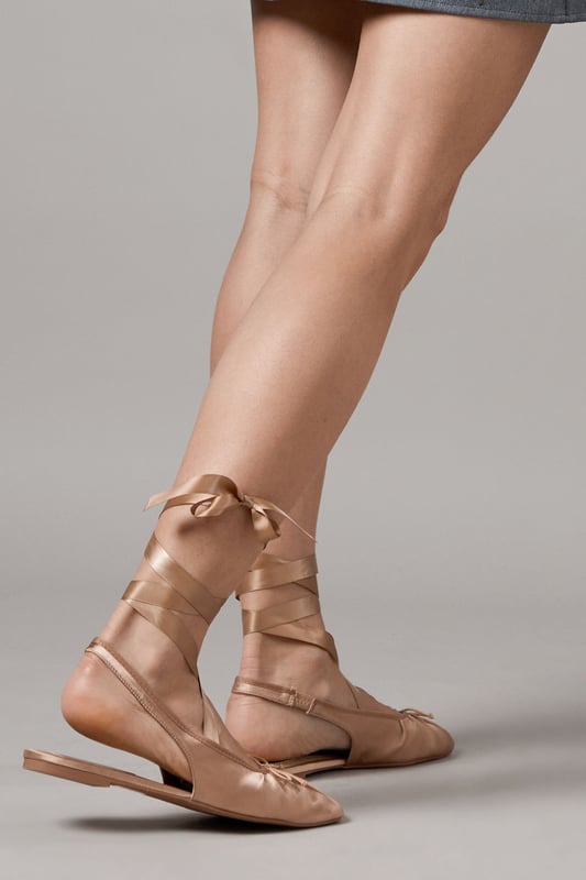 Luxurious satin ballet pumps with elegant ankle tie detail
        Comfortable flat heel measuring between 0-2cm for all-day wear
        Delicate slingback design with secure ribbon ties
        Soft gathered detail at the toe for a feminine finish
        Versatile pointed toe silhouette perfect for both casual and formal styling
    
    The Faith Lia Ballet Pumps combine timeless elegance with contemporary styling. These sophisticated flats feature sumptuous satin fabric that catches the light beautifully, whilst the ankle-wrap ribbons create a graceful, balletic effect that flatters the leg. Style them as shown with denim for an effortless daytime look, or pair with flowing midi dresses for garden parties and summer weddings. The pointed toe elongates the silhouette, making these an excellent choice for formal occasions when heels aren't practical. The flat design offers comfort without compromising on style, allowing you to dance the night away at special events or navigate cobbled streets during city breaks. These versatile pumps transition seamlessly from day to evening, making them an essential addition to your footwear collection.