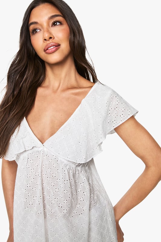 Bridal Broderie Anglaise Frill Cami Top & Shorts Pyjama Set Delicate broderie anglaise fabric with intricate eyelet detailing throughout
Feminine cami top with romantic V-neckline and charming frill overlay
Relaxed fit design for ultimate comfort during your special night
Matching shorts with scalloped hem for a coordinated bridal look
Soft woven fabric that feels gentle against the skin
Make your wedding night as special as your big day with this enchanting broderie anglaise pyjama set from Boohoo. The delicate eyelet detailing and feminine frills create a romantic aesthetic that's perfect for your bridal celebration. The flattering V-neckline and loose-fitting silhouette ensure both style and comfort as you unwind after your wedding festivities. Style with tousled hair and minimal jewellery for an effortlessly beautiful bridal nightwear look. This charming two-piece set strikes the perfect balance between comfort and elegance, making it an ideal addition to your wedding trousseau. The scalloped hem shorts complement the frill-detailed cami top beautifully, creating a cohesive set you'll treasure beyond your wedding night.