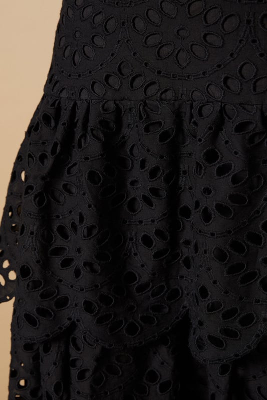 Intricate broderie anglaise detailing with floral eyelet pattern throughout
        Elegant tiered design creates beautiful movement and dimension
        Midi length falls gracefully below the knee for a feminine silhouette
        Scalloped hem adds a delicate finishing touch to each tier
        High-waisted fit accentuates the natural waistline
    
    This charming broderie tiered midi skirt from Oasis combines timeless femininity with contemporary styling. The delicate eyelet pattern creates a romantic texture that catches the light beautifully as you move, while the tiered construction adds playful volume and flow. Style with a denim waistcoat as shown for a balanced casual look, or pair with a fitted blouse for garden parties and family gatherings. The versatile midi length works wonderfully with both ankle boots for cooler days or flat sandals when the temperature rises. This skirt transitions effortlessly from daytime outings to casual evening events - simply switch your accessories to refresh your look. The high-waisted design flatters your figure whilst providing comfort for all-day wear.