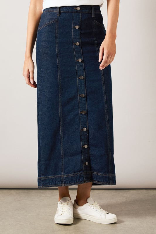 Striking midaxi length denim skirt with distinctive vertical seam detailing
        Front button-through design with metal buttons for a classic denim aesthetic
        Practical side pockets perfect for everyday essentials
        Flattering A-line silhouette that gently flares from the waist
        Subtle back slit detail for ease of movement and added comfort
    
    This sophisticated Seam Detail Midaxi Denim Skirt from Wallis combines timeless style with contemporary design. The vertical seam detailing creates a slimming effect while the classic button-through front adds a touch of casual charm. Style with a simple white t-shirt and leather sandals for relaxed weekend brunches, or pair with a tucked-in blouse and ballet flats for family gatherings. The versatile midaxi length works beautifully for various daytime occasions, from shopping trips to casual lunch dates. For cooler days, layer with a lightweight jumper and trainers for an effortlessly chic look. The cotton fabric provides breathable comfort throughout the day, while the practical pockets add functionality to this wardrobe staple. This skirt transitions seamlessly from season to season, making it a truly versatile addition to your casual collection.