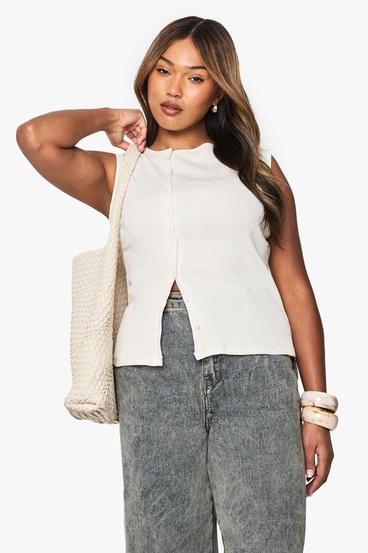 Asymmetrical design with a unique front split
        Sleeveless style for a cool, breezy feel
        Button-down front closure adds a chic touch
        Versatile jersey fabric for comfort and style
        Plus-size fit tailored for curvy figures
    
    Make a statement with this eye-catching asymmetrical top from Boohoo. The sleek, sleeveless design is perfect for those warm summer days, while the button-down front adds a touch of sophistication. The jersey fabric ensures all-day comfort, making it ideal for various casual occasions. Style it with acid-wash jeans and trainers for a trendy daytime look, or dress it up with a midi skirt and strappy sandals for evening drinks with friends. The asymmetrical hem creates a flattering silhouette, perfect for family gatherings or casual outings. Layer it with a lightweight cardigan for cooler evenings, or pair it with statement jewellery to elevate your ensemble. This versatile top is a must-have addition to any fashion-forward wardrobe, offering endless styling possibilities for the confident, curve-embracing Boohoo woman.