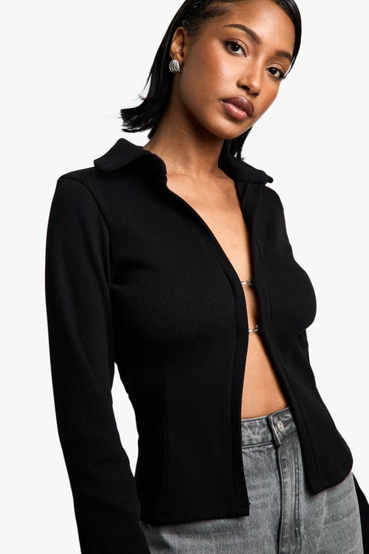 Chic collared long-sleeve top
        Fitted silhouette for a flattering shape
        Versatile open-front design
        Ribbed texture for added interest
        Cropped length to accentuate the waist
    
    This long-sleeved collared top from Boohoo is the perfect blend of sophistication and edge. The fitted silhouette hugs your curves, while the open front design allows for endless styling possibilities. Pair it with high-waisted wide-leg jeans and trainers for a casual day out, or dress it up with a sleek midi skirt and heels for a night on the town. The ribbed texture adds a touch of intrigue, making it stand out from your average top. Its versatility shines through as it can be worn open as a lightweight jacket or closed for a more polished look. The cropped length is ideal for highlighting your waistline and works brilliantly with high-rise bottoms. Whether you're heading to a family gathering or meeting friends for brunch, this top will keep you looking effortlessly stylish.