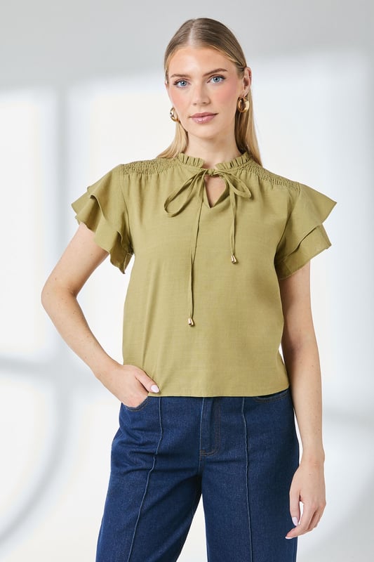 Charming bubble hem design creates a flattering silhouette
        Feminine flute sleeves with delicate ruffle detail
        Elegant V-neckline with tie detail for adjustable styling
        Gathered neckline adds texture and visual interest
        Regular fit in soft cotton-blend fabric for all-day comfort
    
    This Principles top combines playful elements with everyday wearability. The distinctive bubble hem creates a relaxed shape that skims the body beautifully, whilst the flute sleeves add a touch of feminine flair. Style with your favourite denim jeans and trainers for weekend brunches, or dress up with tailored trousers and ballet flats for casual office days. The versatile design works brilliantly for family gatherings and informal social occasions - simply add statement earrings and a crossbody bag to complete the look. The cotton-blend fabric ensures breathability and comfort throughout the day, making this top a practical yet stylish addition to your daywear collection. Perfect for the transitional seasons when layered under a lightweight cardigan or denim jacket.
