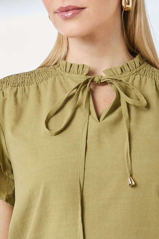 Charming bubble hem design creates a flattering silhouette
        Feminine flute sleeves with delicate ruffle detail
        Elegant V-neckline with tie detail for adjustable styling
        Gathered neckline adds texture and visual interest
        Regular fit in soft cotton-blend fabric for all-day comfort
    
    This Principles top combines playful elements with everyday wearability. The distinctive bubble hem creates a relaxed shape that skims the body beautifully, whilst the flute sleeves add a touch of feminine flair. Style with your favourite denim jeans and trainers for weekend brunches, or dress up with tailored trousers and ballet flats for casual office days. The versatile design works brilliantly for family gatherings and informal social occasions - simply add statement earrings and a crossbody bag to complete the look. The cotton-blend fabric ensures breathability and comfort throughout the day, making this top a practical yet stylish addition to your daywear collection. Perfect for the transitional seasons when layered under a lightweight cardigan or denim jacket.