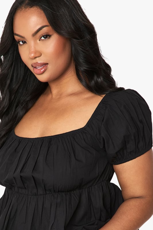 Flattering Bardot neckline with elegant ruched detailing
        Soft cotton fabric for all-day comfort
        Feminine puff sleeves with elasticated cuffs
        Gathered peplum hem creating a figure-enhancing silhouette
        Versatile design that can be worn on or off the shoulder
    
    This charming ruched Bardot top from Boohoo combines casual comfort with effortless style. The gathered detailing across the neckline creates a feminine look whilst the peplum hem adds a flattering shape to your silhouette. Style with white shorts and flat sandals for daytime outings as shown, or dress up with your favourite denim jeans and trainers for casual drinks with friends. The cotton fabric ensures breathability for those warmer days, whilst the elasticated elements provide a comfortable fit that moves with you. Perfect for family gatherings or weekend brunches, this top offers versatility for your everyday wardrobe. Add simple jewellery and a crossbody bag to complete this relaxed yet put-together look.