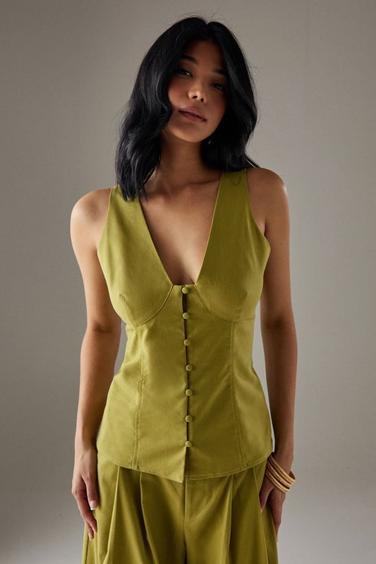 Sleeveless button-through design with striking plunging V-neckline
        Structured bodice with flattering seam detailing for a defined silhouette
        Elegant square-cut back adding a contemporary twist
        Linen blend fabric offering breathable comfort with natural texture
        Versatile length perfect for tucking or wearing loose
    
    This sophisticated sleeveless top from Warehouse radiates confidence with its bold V-neckline and button-through front. The structured bodice creates a feminine silhouette that works beautifully for daytime occasions. Style with the matching wide-leg trousers as shown for an effortlessly coordinated look, or pair with your favourite denim and trainers for casual weekend brunches. The square-cut back adds interest when layered under a lightweight cardigan or denim jacket for cooler days. Perfect for family gatherings or alfresco dining, this versatile piece transitions seamlessly from day to evening - simply swap your flat sandals for block heels and add statement jewellery. The textured linen blend fabric offers a natural drape that maintains its shape throughout the day whilst providing breathable comfort.