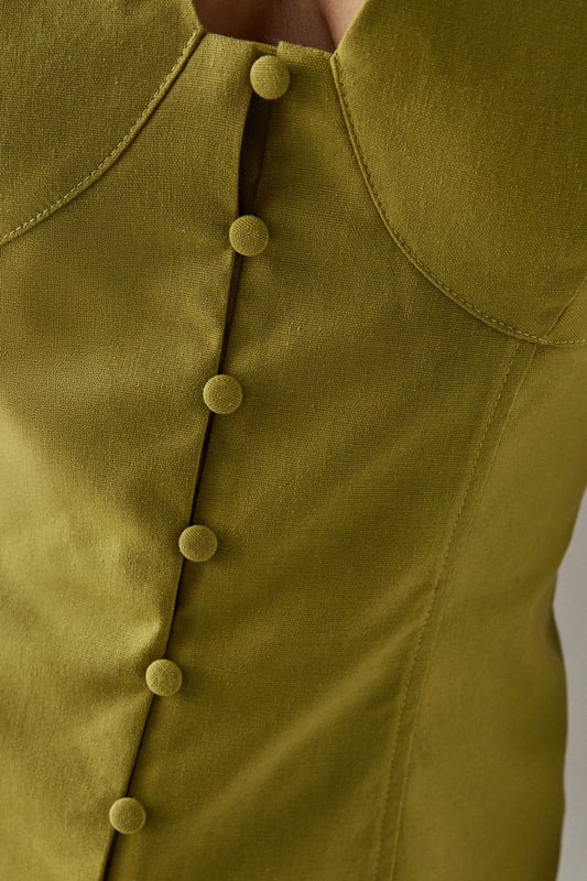 Sleeveless button-through design with striking plunging V-neckline
        Structured bodice with flattering seam detailing for a defined silhouette
        Elegant square-cut back adding a contemporary twist
        Linen blend fabric offering breathable comfort with natural texture
        Versatile length perfect for tucking or wearing loose
    
    This sophisticated sleeveless top from Warehouse radiates confidence with its bold V-neckline and button-through front. The structured bodice creates a feminine silhouette that works beautifully for daytime occasions. Style with the matching wide-leg trousers as shown for an effortlessly coordinated look, or pair with your favourite denim and trainers for casual weekend brunches. The square-cut back adds interest when layered under a lightweight cardigan or denim jacket for cooler days. Perfect for family gatherings or alfresco dining, this versatile piece transitions seamlessly from day to evening - simply swap your flat sandals for block heels and add statement jewellery. The textured linen blend fabric offers a natural drape that maintains its shape throughout the day whilst providing breathable comfort.
