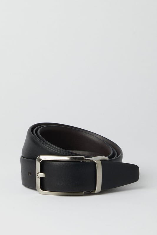 Reversible design offers two distinct looks in one versatile belt
        Sleek metal buckle with rectangular frame for a contemporary finish
        Multiple belt holes for adjustable comfort and perfect fit
        Crafted from genuine leather for durability and timeless appeal
        Clean-edge construction provides a refined, sophisticated silhouette
    
    This reversible leather belt delivers exceptional versatility for the modern gentleman. Effortlessly transition between smart and casual settings by simply flipping the belt to reveal its alternate side. The understated rectangular buckle complements both formal trousers and smart denim alike, making it an essential wardrobe staple. Style with tailored grey trousers and a crisp white shirt for important meetings, or pair with chinos and a button-down for weekend gatherings at the local. The genuine leather construction ensures this belt will age beautifully with wear, developing a unique patina over time. Perfect for the man who appreciates classic styling with practical functionality - this belt offers enduring style that works seamlessly from office to evening drinks without missing a beat.
