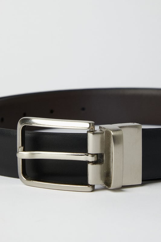Reversible design offers two distinct looks in one versatile belt
        Sleek metal buckle with rectangular frame for a contemporary finish
        Multiple belt holes for adjustable comfort and perfect fit
        Crafted from genuine leather for durability and timeless appeal
        Clean-edge construction provides a refined, sophisticated silhouette
    
    This reversible leather belt delivers exceptional versatility for the modern gentleman. Effortlessly transition between smart and casual settings by simply flipping the belt to reveal its alternate side. The understated rectangular buckle complements both formal trousers and smart denim alike, making it an essential wardrobe staple. Style with tailored grey trousers and a crisp white shirt for important meetings, or pair with chinos and a button-down for weekend gatherings at the local. The genuine leather construction ensures this belt will age beautifully with wear, developing a unique patina over time. Perfect for the man who appreciates classic styling with practical functionality - this belt offers enduring style that works seamlessly from office to evening drinks without missing a beat.