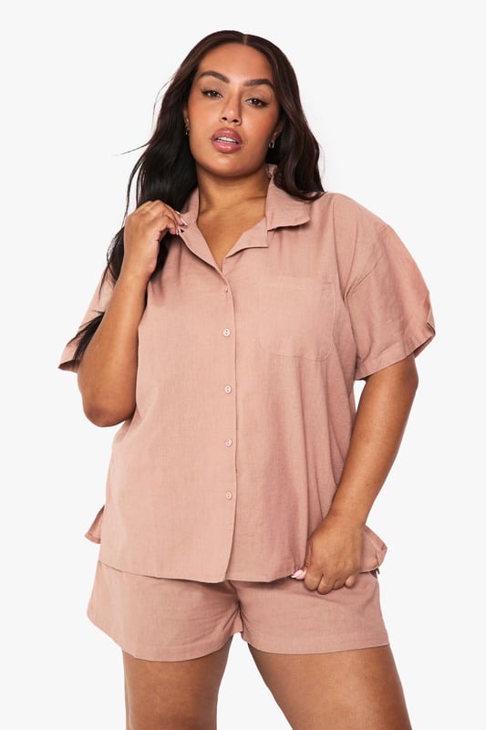 Relaxed linen-look co-ord featuring a short-sleeved shirt with classic collar and button-through front
        Comfortable shorts with elastic waistband for easy wear and perfect fit
        Practical chest pocket detail on the shirt adds a touch of casual sophistication
        Versatile two-piece set that can be worn together or styled separately
        Breathable fabric ideal for warm weather and holiday packing
    
    This effortlessly chic linen-look co-ord is your warm-weather wardrobe essential. The breezy short-sleeved shirt with its relaxed fit pairs perfectly with the comfortable elastic-waist shorts for a coordinated look that requires minimal effort. Style with trainers and a woven tote bag for casual daytime outings, or dress up with leather sandals and delicate jewellery for family gatherings and brunches with friends. The versatility of this set cannot be overstated - wear together for an instantly put-together appearance or mix with other wardrobe staples for multiple outfit options. The breathable fabric makes this an ideal choice for city breaks, beach holidays or simply lounging at home when temperatures rise. A true capsule wardrobe hero that combines comfort and style in equal measure.