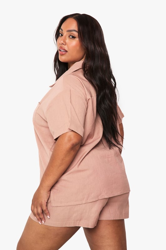 Relaxed linen-look co-ord featuring a short-sleeved shirt with classic collar and button-through front
        Comfortable shorts with elastic waistband for easy wear and perfect fit
        Practical chest pocket detail on the shirt adds a touch of casual sophistication
        Versatile two-piece set that can be worn together or styled separately
        Breathable fabric ideal for warm weather and holiday packing
    
    This effortlessly chic linen-look co-ord is your warm-weather wardrobe essential. The breezy short-sleeved shirt with its relaxed fit pairs perfectly with the comfortable elastic-waist shorts for a coordinated look that requires minimal effort. Style with trainers and a woven tote bag for casual daytime outings, or dress up with leather sandals and delicate jewellery for family gatherings and brunches with friends. The versatility of this set cannot be overstated - wear together for an instantly put-together appearance or mix with other wardrobe staples for multiple outfit options. The breathable fabric makes this an ideal choice for city breaks, beach holidays or simply lounging at home when temperatures rise. A true capsule wardrobe hero that combines comfort and style in equal measure.