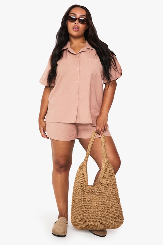 Relaxed linen-look co-ord featuring a short-sleeved shirt with classic collar and button-through front
        Comfortable shorts with elastic waistband for easy wear and perfect fit
        Practical chest pocket detail on the shirt adds a touch of casual sophistication
        Versatile two-piece set that can be worn together or styled separately
        Breathable fabric ideal for warm weather and holiday packing
    
    This effortlessly chic linen-look co-ord is your warm-weather wardrobe essential. The breezy short-sleeved shirt with its relaxed fit pairs perfectly with the comfortable elastic-waist shorts for a coordinated look that requires minimal effort. Style with trainers and a woven tote bag for casual daytime outings, or dress up with leather sandals and delicate jewellery for family gatherings and brunches with friends. The versatility of this set cannot be overstated - wear together for an instantly put-together appearance or mix with other wardrobe staples for multiple outfit options. The breathable fabric makes this an ideal choice for city breaks, beach holidays or simply lounging at home when temperatures rise. A true capsule wardrobe hero that combines comfort and style in equal measure.