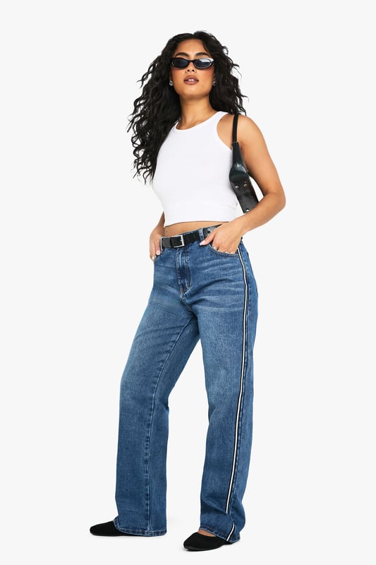 Straight leg jeans with eye-catching side stripe detail
        High-rise waist for a flattering silhouette
        Classic five-pocket design for practicality
        Belt loops for versatile styling options
        Comfortable cotton-blend fabric for all-day wear
    
    Make a statement with these trendy straight leg jeans from Boohoo. The standout side stripe adds a contemporary twist to a timeless denim staple, perfect for the fashion-forward woman who loves to stay ahead of the curve. Pair these jeans with a cropped vest top and trainers for a casual daytime look that's both comfortable and stylish. For a more polished ensemble, team with a crisp white shirt and ankle boots. The versatile design makes these jeans suitable for various casual occasions, from coffee dates with friends to family gatherings. The high-rise waist and straight leg cut create a flattering silhouette that complements a range of body types, embodying Boohoo's commitment to inclusivity. Embrace your individuality and make these jeans the cornerstone of your casual wardrobe.
