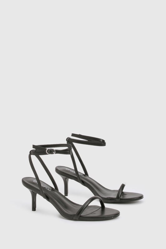 Elegant strappy design with delicate ankle wrap detail
        Low heel height between 2.5-4.5cm for comfortable all-night wear
        Minimalist open-toe silhouette for a contemporary look
        Secure ankle buckle fastening for adjustable fit
        Versatile styling potential for both casual and dressed-up occasions
    
    These essential Basic Heels from Boohoo deliver the perfect balance of style and practicality for your night-out wardrobe. The sleek, minimalist design features thin straps that gracefully frame the foot, while the ankle wrap detail adds a touch of sophistication. The low heel provides just enough height to enhance your silhouette without sacrificing comfort during long evenings out. Style these versatile heels with a figure-hugging midi dress and statement earrings for cocktails with the girls, or pair with your favourite jeans and a silky camisole for a more relaxed evening look. The understated design makes these heels an ideal foundation piece for countless outfits, ensuring they'll become a go-to choice whenever you're planning a night on the town. Their timeless appeal means they'll remain a staple in your collection season after season.