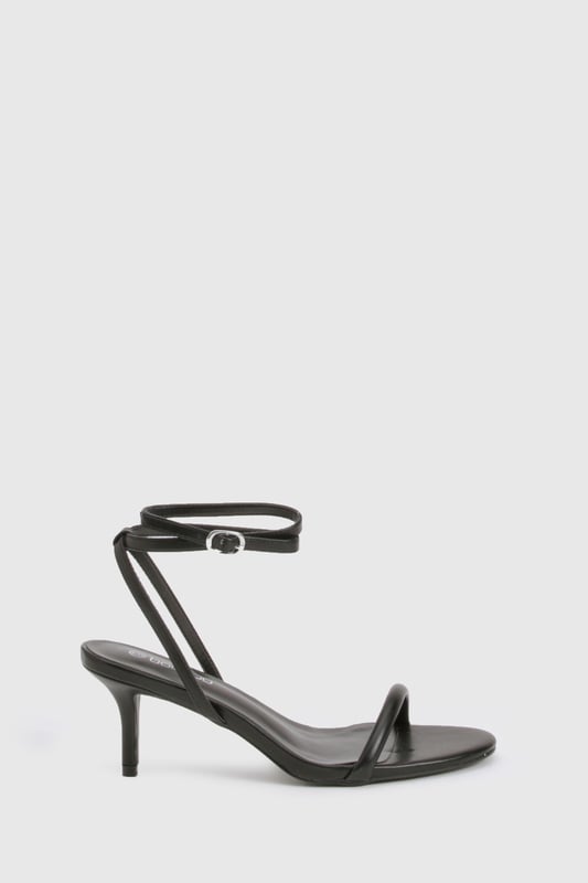 Elegant strappy design with delicate ankle wrap detail
        Low heel height between 2.5-4.5cm for comfortable all-night wear
        Minimalist open-toe silhouette for a contemporary look
        Secure ankle buckle fastening for adjustable fit
        Versatile styling potential for both casual and dressed-up occasions
    
    These essential Basic Heels from Boohoo deliver the perfect balance of style and practicality for your night-out wardrobe. The sleek, minimalist design features thin straps that gracefully frame the foot, while the ankle wrap detail adds a touch of sophistication. The low heel provides just enough height to enhance your silhouette without sacrificing comfort during long evenings out. Style these versatile heels with a figure-hugging midi dress and statement earrings for cocktails with the girls, or pair with your favourite jeans and a silky camisole for a more relaxed evening look. The understated design makes these heels an ideal foundation piece for countless outfits, ensuring they'll become a go-to choice whenever you're planning a night on the town. Their timeless appeal means they'll remain a staple in your collection season after season.