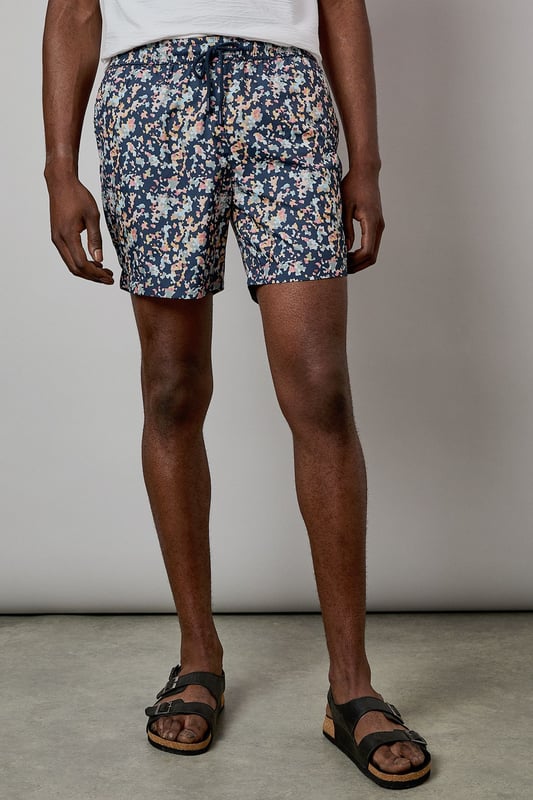 Eye-catching sunset camo print design for standout poolside style
        Quick-drying fabric for comfort both in and out of the water
        Adjustable drawstring waist for a customised fit
        Practical side pockets for essentials
        Mid-thigh length offering comfortable coverage and freedom of movement
    
    These Burton swim shorts showcase a distinctive sunset camo print that brings character to your holiday wardrobe. Perfect for beach days, pool parties or casual summer outings, they offer both style and practicality. The mid-thigh length presents a modern silhouette that suits most body types, while the adjustable waistband ensures comfort throughout the day. Style them as seen with a crisp white t-shirt and sandals for an effortless daytime look, or pair with a linen shirt when heading from beach to bar. These versatile shorts transition seamlessly from swimming to socialising, making them an essential for summer getaways, garden barbecues or simply relaxing at your local lido. Ideal for the man who appreciates classic styling with a contemporary twist, these swim shorts will become a seasonal favourite in your warm-weather collection.