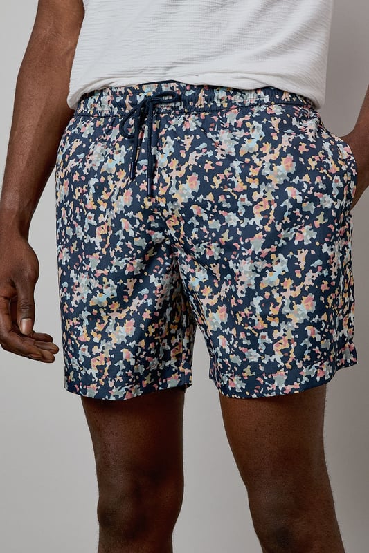 Eye-catching sunset camo print design for standout poolside style
        Quick-drying fabric for comfort both in and out of the water
        Adjustable drawstring waist for a customised fit
        Practical side pockets for essentials
        Mid-thigh length offering comfortable coverage and freedom of movement
    
    These Burton swim shorts showcase a distinctive sunset camo print that brings character to your holiday wardrobe. Perfect for beach days, pool parties or casual summer outings, they offer both style and practicality. The mid-thigh length presents a modern silhouette that suits most body types, while the adjustable waistband ensures comfort throughout the day. Style them as seen with a crisp white t-shirt and sandals for an effortless daytime look, or pair with a linen shirt when heading from beach to bar. These versatile shorts transition seamlessly from swimming to socialising, making them an essential for summer getaways, garden barbecues or simply relaxing at your local lido. Ideal for the man who appreciates classic styling with a contemporary twist, these swim shorts will become a seasonal favourite in your warm-weather collection.
