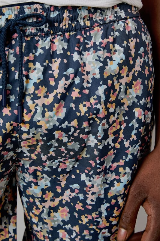 Eye-catching sunset camo print design for standout poolside style
        Quick-drying fabric for comfort both in and out of the water
        Adjustable drawstring waist for a customised fit
        Practical side pockets for essentials
        Mid-thigh length offering comfortable coverage and freedom of movement
    
    These Burton swim shorts showcase a distinctive sunset camo print that brings character to your holiday wardrobe. Perfect for beach days, pool parties or casual summer outings, they offer both style and practicality. The mid-thigh length presents a modern silhouette that suits most body types, while the adjustable waistband ensures comfort throughout the day. Style them as seen with a crisp white t-shirt and sandals for an effortless daytime look, or pair with a linen shirt when heading from beach to bar. These versatile shorts transition seamlessly from swimming to socialising, making them an essential for summer getaways, garden barbecues or simply relaxing at your local lido. Ideal for the man who appreciates classic styling with a contemporary twist, these swim shorts will become a seasonal favourite in your warm-weather collection.