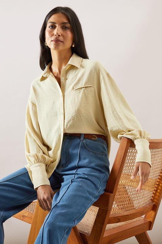 Pocket Detail Relaxed Collared Shirt Relaxed fit collared shirt with elegant chest pocket detail
Voluminous balloon sleeves with fitted cuffs for a feminine silhouette
Soft woven fabric with slight stretch for all-day comfort
Classic button-through front with sophisticated collar design
Curved hem perfect for both tucked or untucked styling options
This versatile Wallis shirt combines sophistication with everyday comfort. The relaxed silhouette drapes beautifully over the body while the distinctive pocket detail adds a touch of refinement. Style it as shown with wide-leg denim trousers and trainers for a polished daytime look, or tuck the front into tailored trousers for family gatherings. The balloon sleeves create a contemporary shape that transitions effortlessly from office to weekend brunch. For cooler days, layer under a lightweight cardigan or pair with your favourite jeans and ankle boots. The collared neckline frames the face beautifully, making this shirt an essential addition to your daywear collection - perfect for those occasions when you want to feel put-together yet comfortable.