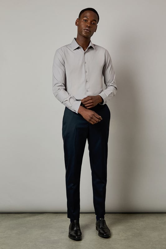 Slim fit design with a tailored silhouette that contours to your frame
        Easy iron fabric technology for effortless maintenance and crease-free wear
        Classic collar with structured points for a refined appearance
        Long sleeves with adjustable button cuffs for versatile styling options
        Subtle button placket with tonal buttons for a sleek, contemporary finish
    
    This Burton shirt combines practicality with polished style, making it a wardrobe essential for the modern gentleman. The slim fit creates a sharp silhouette without sacrificing comfort, whilst the easy iron technology ensures you'll look impeccable with minimal effort. Perfect for the office paired with tailored trousers as shown, or dressed down with dark denim for after-work drinks. The versatile design transitions seamlessly from important meetings to smart casual events - simply remove your tie and open the top button for a more relaxed look. For cooler evenings, layer under a fine merino jumper or structured blazer to maintain that sophisticated edge. This shirt represents the hallmark of Burton's commitment to creating reliable, stylish staples that work as hard as you do.