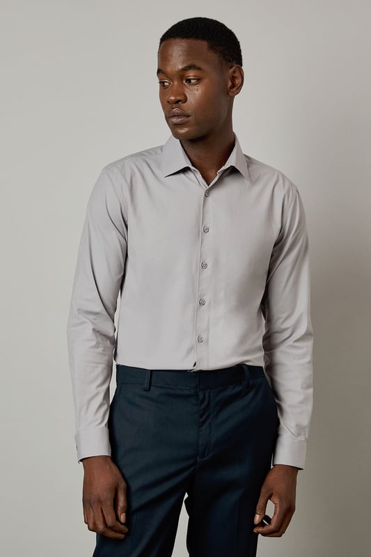 Slim fit design with a tailored silhouette that contours to your frame
        Easy iron fabric technology for effortless maintenance and crease-free wear
        Classic collar with structured points for a refined appearance
        Long sleeves with adjustable button cuffs for versatile styling options
        Subtle button placket with tonal buttons for a sleek, contemporary finish
    
    This Burton shirt combines practicality with polished style, making it a wardrobe essential for the modern gentleman. The slim fit creates a sharp silhouette without sacrificing comfort, whilst the easy iron technology ensures you'll look impeccable with minimal effort. Perfect for the office paired with tailored trousers as shown, or dressed down with dark denim for after-work drinks. The versatile design transitions seamlessly from important meetings to smart casual events - simply remove your tie and open the top button for a more relaxed look. For cooler evenings, layer under a fine merino jumper or structured blazer to maintain that sophisticated edge. This shirt represents the hallmark of Burton's commitment to creating reliable, stylish staples that work as hard as you do.