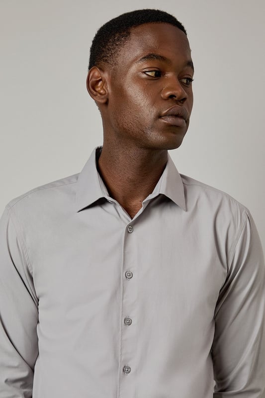 Slim fit design with a tailored silhouette that contours to your frame
        Easy iron fabric technology for effortless maintenance and crease-free wear
        Classic collar with structured points for a refined appearance
        Long sleeves with adjustable button cuffs for versatile styling options
        Subtle button placket with tonal buttons for a sleek, contemporary finish
    
    This Burton shirt combines practicality with polished style, making it a wardrobe essential for the modern gentleman. The slim fit creates a sharp silhouette without sacrificing comfort, whilst the easy iron technology ensures you'll look impeccable with minimal effort. Perfect for the office paired with tailored trousers as shown, or dressed down with dark denim for after-work drinks. The versatile design transitions seamlessly from important meetings to smart casual events - simply remove your tie and open the top button for a more relaxed look. For cooler evenings, layer under a fine merino jumper or structured blazer to maintain that sophisticated edge. This shirt represents the hallmark of Burton's commitment to creating reliable, stylish staples that work as hard as you do.