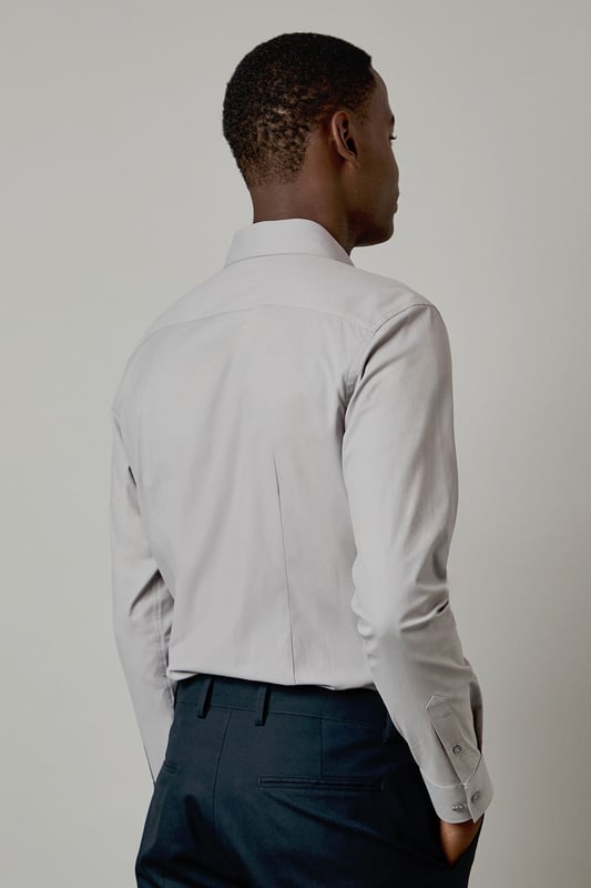 Slim fit design with a tailored silhouette that contours to your frame
        Easy iron fabric technology for effortless maintenance and crease-free wear
        Classic collar with structured points for a refined appearance
        Long sleeves with adjustable button cuffs for versatile styling options
        Subtle button placket with tonal buttons for a sleek, contemporary finish
    
    This Burton shirt combines practicality with polished style, making it a wardrobe essential for the modern gentleman. The slim fit creates a sharp silhouette without sacrificing comfort, whilst the easy iron technology ensures you'll look impeccable with minimal effort. Perfect for the office paired with tailored trousers as shown, or dressed down with dark denim for after-work drinks. The versatile design transitions seamlessly from important meetings to smart casual events - simply remove your tie and open the top button for a more relaxed look. For cooler evenings, layer under a fine merino jumper or structured blazer to maintain that sophisticated edge. This shirt represents the hallmark of Burton's commitment to creating reliable, stylish staples that work as hard as you do.