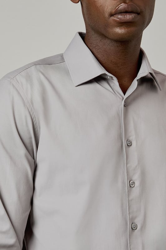 Slim fit design with a tailored silhouette that contours to your frame
        Easy iron fabric technology for effortless maintenance and crease-free wear
        Classic collar with structured points for a refined appearance
        Long sleeves with adjustable button cuffs for versatile styling options
        Subtle button placket with tonal buttons for a sleek, contemporary finish
    
    This Burton shirt combines practicality with polished style, making it a wardrobe essential for the modern gentleman. The slim fit creates a sharp silhouette without sacrificing comfort, whilst the easy iron technology ensures you'll look impeccable with minimal effort. Perfect for the office paired with tailored trousers as shown, or dressed down with dark denim for after-work drinks. The versatile design transitions seamlessly from important meetings to smart casual events - simply remove your tie and open the top button for a more relaxed look. For cooler evenings, layer under a fine merino jumper or structured blazer to maintain that sophisticated edge. This shirt represents the hallmark of Burton's commitment to creating reliable, stylish staples that work as hard as you do.