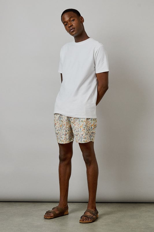 Distinctive sunset camo print swim shorts with a relaxed mid-thigh length
        Comfortable elasticated waistband with adjustable drawstring for a secure fit
        Quick-drying fabric ideal for beach days and poolside lounging
        Versatile design suitable for both swimming and casual summer wear
        Relaxed fit allowing for ease of movement during activities
    
    These Burton swim shorts showcase a distinctive sunset camo print that brings a subtle touch of personality to your summer wardrobe. Perfect for the man who appreciates classic style with a contemporary twist, these shorts transition effortlessly from beach to bar. Pair them with a simple white tee and leather sandals for a relaxed daytime look, or throw on a linen shirt for evening drinks by the sea. The mid-thigh length offers a flattering silhouette without restricting movement, making them ideal for everything from a casual swim to a game of beach volleyball with mates. Comfortable enough for all-day wear during family barbecues or festival weekends, these shorts reflect the practical yet stylish ethos that Burton is known for. Machine washable for easy care, they'll quickly become your go-to for summer adventures and holiday packing.
