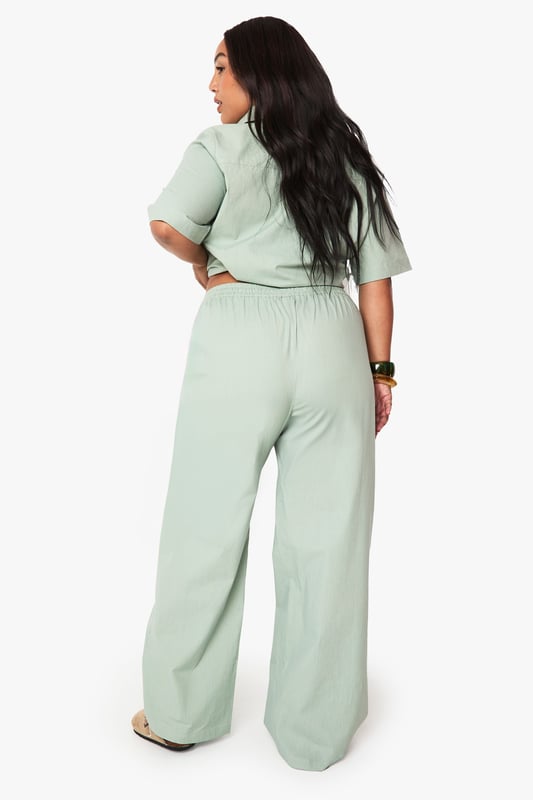 Cotton fabric provides breathable comfort for all-day wear
        Wide leg design offers a relaxed, flowing silhouette
        Elasticated waistband ensures a comfortable, adjustable fit
        Plus size tailoring designed specifically for curvier figures
        Versatile trousers that transition effortlessly from day to evening
    
    These wide leg cotton trousers from Boohoo deliver both comfort and contemporary style for the fashion-forward woman. The relaxed silhouette creates a flattering drape that moves beautifully with every step, whilst the soft cotton fabric ensures breathability throughout the day. Style them as shown with a matching button-up shirt for a coordinated set that projects confidence and sophistication. For casual outings, pair with trainers and a cropped tee, or dress them up for family gatherings with a fitted blouse and statement jewellery. The versatile design works brilliantly with both fitted and oversized tops, making these trousers a wardrobe essential that can be styled countless ways. Perfect for those seeking comfort without compromising on style.