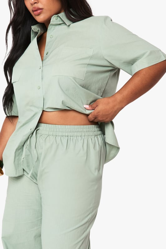 Cotton fabric provides breathable comfort for all-day wear
        Wide leg design offers a relaxed, flowing silhouette
        Elasticated waistband ensures a comfortable, adjustable fit
        Plus size tailoring designed specifically for curvier figures
        Versatile trousers that transition effortlessly from day to evening
    
    These wide leg cotton trousers from Boohoo deliver both comfort and contemporary style for the fashion-forward woman. The relaxed silhouette creates a flattering drape that moves beautifully with every step, whilst the soft cotton fabric ensures breathability throughout the day. Style them as shown with a matching button-up shirt for a coordinated set that projects confidence and sophistication. For casual outings, pair with trainers and a cropped tee, or dress them up for family gatherings with a fitted blouse and statement jewellery. The versatile design works brilliantly with both fitted and oversized tops, making these trousers a wardrobe essential that can be styled countless ways. Perfect for those seeking comfort without compromising on style.