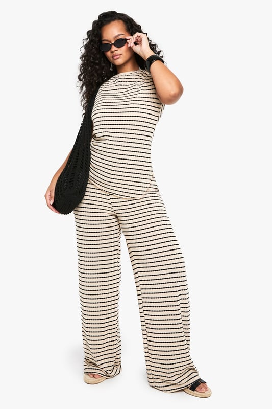 Striking striped pattern for a bold, eye-catching look
        Wide-leg silhouette offers comfort and style
        High-waisted design with drawstring for adjustable fit
        Soft jersey fabric ensures all-day comfort
        Versatile piece suitable for various casual occasions
    
    Make a statement with these trendy wide-leg trousers, perfect for the fashion-forward woman who values both style and comfort. The eye-catching striped pattern adds a touch of flair to your ensemble, while the relaxed wide-leg cut ensures ease of movement. Pair these trousers with a cropped top and oversized sunglasses for a chic daytime look, or dress them up with a fitted blouse and statement jewellery for a casual evening out. The high-waisted design with an adjustable drawstring allows for a customised fit, making these trousers suitable for a range of body types. Ideal for family gatherings, brunches with friends, or a day of shopping, these versatile trousers will quickly become a staple in your wardrobe. The soft jersey fabric promises comfort throughout the day, whether you're running errands or lounging at home. Complete the look with flat sandals or trainers for an effortlessly cool vibe that embodies the Boohoo spirit.