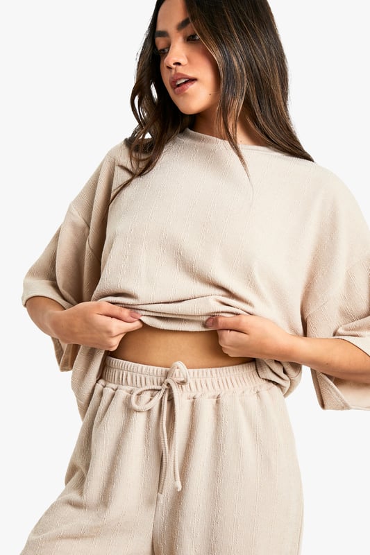 Oversized T-shirt with relaxed fit and dropped shoulders
        Wide-leg trousers with comfortable, flowy silhouette
        Coordinated set for effortless style
        Drawstring waist on trousers for adjustable fit
        Versatile neutral tone suitable for various occasions
    
    Embrace laid-back chic with this effortlessly cool oversized T-shirt and wide-leg trouser co-ord from Boohoo. The relaxed fit of the top, featuring dropped shoulders, pairs perfectly with the flowy silhouette of the trousers, creating a harmonious ensemble that's both comfortable and on-trend. Ideal for casual outings or lounging at home, this set can be easily dressed up or down. Style it with trainers and a leather jacket for a street-smart look, or pair with statement jewellery and heeled sandals for a more polished appearance. The drawstring waist on the trousers allows for a customised fit, while the neutral tone of the set offers endless styling possibilities. Whether you're meeting friends for brunch or running errands, this co-ord set promises to keep you looking effortlessly stylish without compromising on comfort.