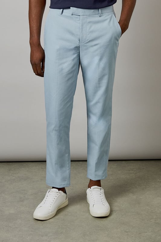Crafted from a cotton-linen blend fabric for breathable comfort and a natural texture
        Slim fit design offers a modern, tailored silhouette that flatters the leg
        Clean front with side pockets and button-through back pockets for practicality
        Versatile light hue perfect for seasonal dressing throughout spring and summer
        Crisp centre crease adds structure and a refined finishing touch
    
    These Burton slim fit suit trousers combine classic tailoring with contemporary style. The cotton-linen blend fabric delivers a lightweight feel that's ideal for warmer weather whilst maintaining a smart appearance. Style with the matching jacket for formal occasions, or dress down with a navy crew neck and white trainers as shown for smart-casual events. The clean lines and refined cut make these trousers particularly suitable for summer weddings, garden parties, or race days. For the office, pair with a crisp shirt and loafers for a sophisticated look that transitions seamlessly from day to evening. The natural fabric blend allows for comfort during extended wear, making these trousers a practical yet stylish addition to any gentleman's wardrobe - perfect for the man who appreciates timeless style with modern sensibility.