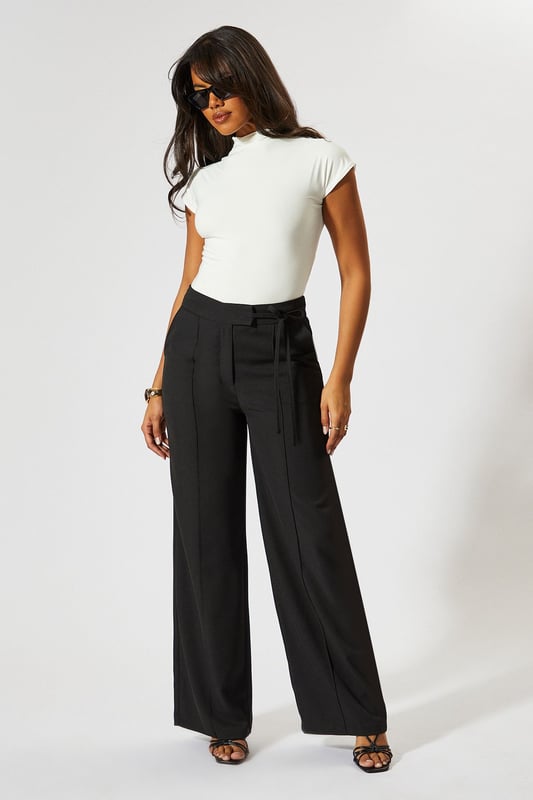 Wide leg silhouette for a relaxed, on-trend look
        Tie-side detail adds a unique, customisable touch
        High-waisted design for a flattering fit
        Tailored construction offers a polished appearance
        Side pockets for practicality and style
    
    Make a statement with these wide leg tie side tailored trousers from MissPap. Perfect for the fashion-forward woman who loves to stand out, these trousers blend comfort with chic style. The high-waisted design elongates your silhouette, while the wide leg cut creates a dramatic, flowing effect as you move. Dress them up for a night out with a crop top and strappy heels, or keep it casual for daytime events with a fitted tee and trainers. The tie-side detail allows you to adjust the fit to your liking, adding a personalised touch to your look. Whether you're heading to a family gathering or meeting friends for brunch, these versatile trousers will ensure you're always dressed to impress. Pair with a sleek blazer for a more formal occasion, or throw on an oversized jumper for a cosy yet stylish ensemble.