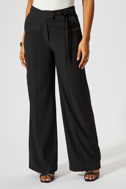 Wide leg silhouette for a relaxed, on-trend look
        Tie-side detail adds a unique, customisable touch
        High-waisted design for a flattering fit
        Tailored construction offers a polished appearance
        Side pockets for practicality and style
    
    Make a statement with these wide leg tie side tailored trousers from MissPap. Perfect for the fashion-forward woman who loves to stand out, these trousers blend comfort with chic style. The high-waisted design elongates your silhouette, while the wide leg cut creates a dramatic, flowing effect as you move. Dress them up for a night out with a crop top and strappy heels, or keep it casual for daytime events with a fitted tee and trainers. The tie-side detail allows you to adjust the fit to your liking, adding a personalised touch to your look. Whether you're heading to a family gathering or meeting friends for brunch, these versatile trousers will ensure you're always dressed to impress. Pair with a sleek blazer for a more formal occasion, or throw on an oversized jumper for a cosy yet stylish ensemble.