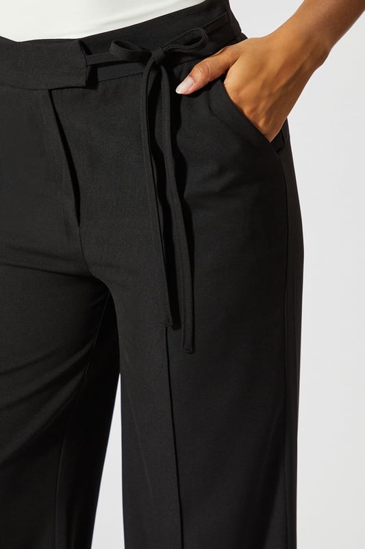 Wide leg silhouette for a relaxed, on-trend look
        Tie-side detail adds a unique, customisable touch
        High-waisted design for a flattering fit
        Tailored construction offers a polished appearance
        Side pockets for practicality and style
    
    Make a statement with these wide leg tie side tailored trousers from MissPap. Perfect for the fashion-forward woman who loves to stand out, these trousers blend comfort with chic style. The high-waisted design elongates your silhouette, while the wide leg cut creates a dramatic, flowing effect as you move. Dress them up for a night out with a crop top and strappy heels, or keep it casual for daytime events with a fitted tee and trainers. The tie-side detail allows you to adjust the fit to your liking, adding a personalised touch to your look. Whether you're heading to a family gathering or meeting friends for brunch, these versatile trousers will ensure you're always dressed to impress. Pair with a sleek blazer for a more formal occasion, or throw on an oversized jumper for a cosy yet stylish ensemble.