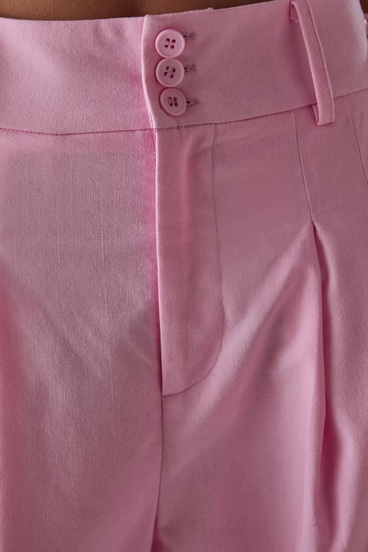 Tailored wide-leg silhouette with a dramatic flowing drape
        Elegant front pleats for added structure and dimension
        Distinctive side tie detail with decorative buttons for a feminine touch
        High-rise waistband designed to flatter the natural waistline
        Linen blend fabric offering breathability and a natural textured finish
    
    These statement trousers from Warehouse combine sophistication with contemporary flair. The wide-leg design creates a striking silhouette that moves beautifully with every step, whilst the tailored pleats add structure and refinement. Style with a simple white tee and flat sandals for effortless daytime chic, or pair with the matching waistcoat for a coordinated ensemble that's perfect for summer gatherings. The versatile design transitions seamlessly from casual brunches to family celebrations - simply swap your trainers for leather slides and add delicate jewellery to enhance the look. The linen blend fabric ensures these trousers remain comfortable throughout the day, making them an essential addition to your warm-weather wardrobe.