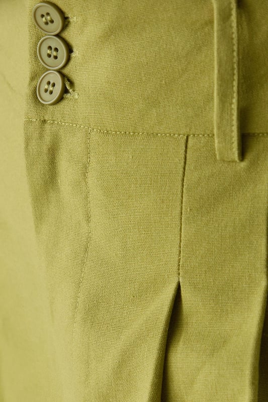 Tailored wide-leg silhouette with a dramatic flowing drape
        Elegant front pleats for added structure and dimension
        Distinctive side tie detail with decorative buttons for a feminine touch
        High-rise waistband designed to flatter the natural waistline
        Linen blend fabric offering breathability and a natural textured finish
    
    These statement trousers from Warehouse combine sophistication with contemporary flair. The wide-leg design creates a striking silhouette that moves beautifully with every step, whilst the tailored pleats add structure and refinement. Style with a simple white tee and flat sandals for effortless daytime chic, or pair with the matching waistcoat for a coordinated ensemble that's perfect for summer gatherings. The versatile design transitions seamlessly from casual brunches to family celebrations - simply swap your trainers for leather slides and add delicate jewellery to enhance the look. The linen blend fabric ensures these trousers remain comfortable throughout the day, making them an essential addition to your warm-weather wardrobe.