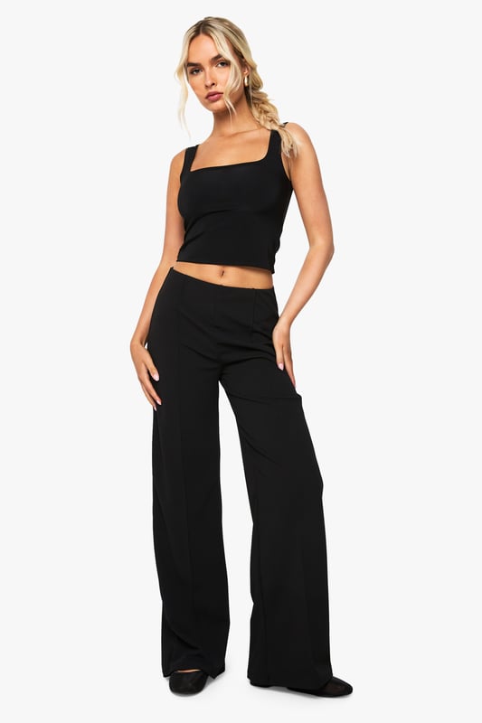 Straight leg design with elegant pintuck detailing for a refined silhouette
        High-rise waistband that sits comfortably at the natural waist
        Flattering front pintuck seams that create a lengthening effect
        Versatile straight cut that complements various body types
        Slight stretch fabric blend for all-day comfort and movement
    
    These Boohoo Straight Leg Pintuck Trousers offer the perfect balance of comfort and style for your everyday wardrobe. The classic straight leg silhouette paired with sophisticated pintuck detailing creates a polished look that works effortlessly from day to night. Style with a matching crop top and blazer for a coordinated ensemble that commands attention at family gatherings, or pair with a casual graphic tee and trainers for weekend brunches. For cooler days, layer with an oversized jumper and ankle boots for a relaxed yet put-together appearance. The versatile design makes these trousers a wardrobe essential that transitions seamlessly between casual settings and smart-casual occasions, offering endless styling possibilities while maintaining comfort throughout your day.