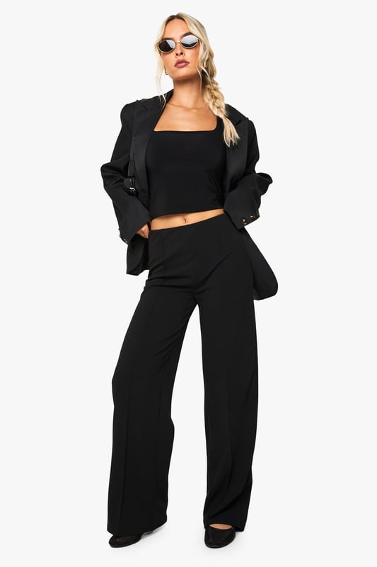 Straight leg design with elegant pintuck detailing for a refined silhouette
        High-rise waistband that sits comfortably at the natural waist
        Flattering front pintuck seams that create a lengthening effect
        Versatile straight cut that complements various body types
        Slight stretch fabric blend for all-day comfort and movement
    
    These Boohoo Straight Leg Pintuck Trousers offer the perfect balance of comfort and style for your everyday wardrobe. The classic straight leg silhouette paired with sophisticated pintuck detailing creates a polished look that works effortlessly from day to night. Style with a matching crop top and blazer for a coordinated ensemble that commands attention at family gatherings, or pair with a casual graphic tee and trainers for weekend brunches. For cooler days, layer with an oversized jumper and ankle boots for a relaxed yet put-together appearance. The versatile design makes these trousers a wardrobe essential that transitions seamlessly between casual settings and smart-casual occasions, offering endless styling possibilities while maintaining comfort throughout your day.