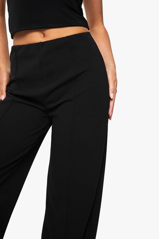 Straight leg design with elegant pintuck detailing for a refined silhouette
        High-rise waistband that sits comfortably at the natural waist
        Flattering front pintuck seams that create a lengthening effect
        Versatile straight cut that complements various body types
        Slight stretch fabric blend for all-day comfort and movement
    
    These Boohoo Straight Leg Pintuck Trousers offer the perfect balance of comfort and style for your everyday wardrobe. The classic straight leg silhouette paired with sophisticated pintuck detailing creates a polished look that works effortlessly from day to night. Style with a matching crop top and blazer for a coordinated ensemble that commands attention at family gatherings, or pair with a casual graphic tee and trainers for weekend brunches. For cooler days, layer with an oversized jumper and ankle boots for a relaxed yet put-together appearance. The versatile design makes these trousers a wardrobe essential that transitions seamlessly between casual settings and smart-casual occasions, offering endless styling possibilities while maintaining comfort throughout your day.