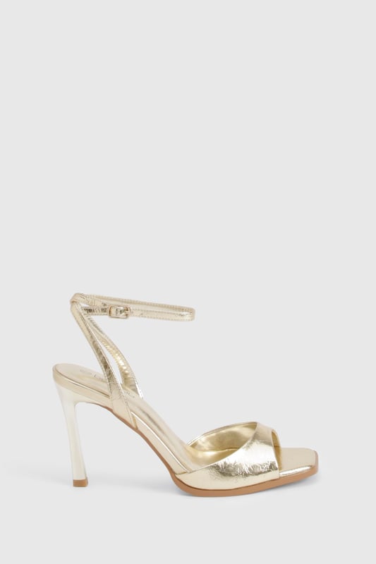 Metallic 2 Part Heels Striking metallic-effect finish that catches the light beautifully
Elegant ankle strap with adjustable buckle fastening for secure fit
Sleek 8cm stiletto heel adds height and sophistication
Minimalist open-toe design showcases pedicures perfectly
Versatile silhouette works for both formal events and night-out looks
These show-stopping metallic heels are the ultimate statement piece for your evening wardrobe. The clean, modern lines and eye-catching finish create a luxurious aesthetic that commands attention without overwhelming your outfit. Style them with a little black dress for classic nightclub glamour, or pair with tailored trousers and a silky camisole when heading out for cocktails. The practical ankle strap ensures comfort and stability throughout the night, while the 8cm heel provides the perfect balance of height and wearability. These versatile heels transition effortlessly from summer weddings to festive celebrations, making them a year-round essential for the fashion-forward woman who values both style and practicality. A true Boohoo classic that delivers maximum impact with minimal effort.
