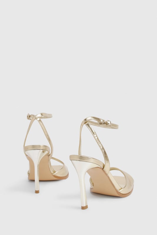 Metallic 2 Part Heels Striking metallic-effect finish that catches the light beautifully
Elegant ankle strap with adjustable buckle fastening for secure fit
Sleek 8cm stiletto heel adds height and sophistication
Minimalist open-toe design showcases pedicures perfectly
Versatile silhouette works for both formal events and night-out looks
These show-stopping metallic heels are the ultimate statement piece for your evening wardrobe. The clean, modern lines and eye-catching finish create a luxurious aesthetic that commands attention without overwhelming your outfit. Style them with a little black dress for classic nightclub glamour, or pair with tailored trousers and a silky camisole when heading out for cocktails. The practical ankle strap ensures comfort and stability throughout the night, while the 8cm heel provides the perfect balance of height and wearability. These versatile heels transition effortlessly from summer weddings to festive celebrations, making them a year-round essential for the fashion-forward woman who values both style and practicality. A true Boohoo classic that delivers maximum impact with minimal effort.