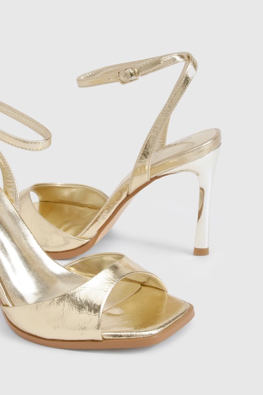 Metallic 2 Part Heels Striking metallic-effect finish that catches the light beautifully
Elegant ankle strap with adjustable buckle fastening for secure fit
Sleek 8cm stiletto heel adds height and sophistication
Minimalist open-toe design showcases pedicures perfectly
Versatile silhouette works for both formal events and night-out looks
These show-stopping metallic heels are the ultimate statement piece for your evening wardrobe. The clean, modern lines and eye-catching finish create a luxurious aesthetic that commands attention without overwhelming your outfit. Style them with a little black dress for classic nightclub glamour, or pair with tailored trousers and a silky camisole when heading out for cocktails. The practical ankle strap ensures comfort and stability throughout the night, while the 8cm heel provides the perfect balance of height and wearability. These versatile heels transition effortlessly from summer weddings to festive celebrations, making them a year-round essential for the fashion-forward woman who values both style and practicality. A true Boohoo classic that delivers maximum impact with minimal effort.