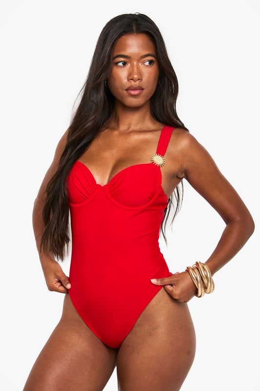 Striking balconette design with structured cups for enhanced shape and support
        Elegant sunshine detail on strap adds a distinctive touch to this swimwear piece
        Flattering high-cut leg line elongates the silhouette
        Adjustable shoulder straps for a customised fit
        Sleek, streamlined design with a smooth finish for a confident poolside look
    
    Make a statement by the pool or on the beach with this eye-catching balconette swimsuit. The structured cups create a flattering silhouette whilst providing excellent support for all-day comfort. The distinctive sunshine detail adds a playful yet sophisticated touch that catches the light beautifully as you lounge by the water. Style with oversized sunglasses and a wide-brimmed hat for ultimate holiday glamour, or layer under a sheer kaftan for elegant poolside drinks. Perfect for everything from active swimming to leisurely sunbathing, this versatile swimsuit transitions effortlessly from day to evening with the addition of a flowing maxi skirt and statement jewellery. The timeless design ensures this piece will remain a holiday favourite for seasons to come.